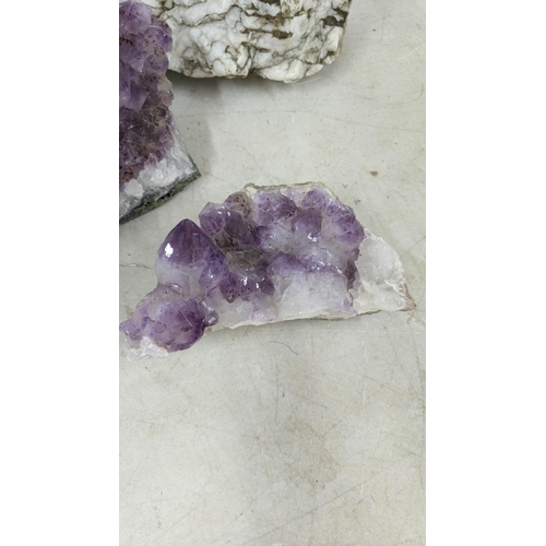 72 - Three large purple amethyst clusters, approx 12cm h x 18cm w, 9.5cm h x 18cm w, 7cm h x 17cm w toget... 