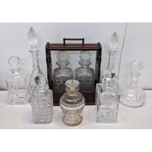 83 - A reproduction mahogany tantalus together with mixed decanters to include a Stuart example
Location:... 