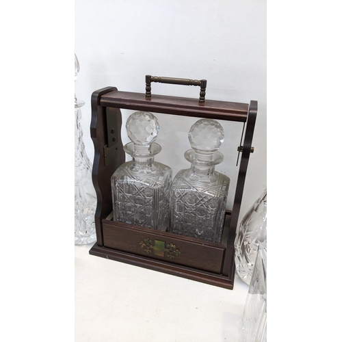 83 - A reproduction mahogany tantalus together with mixed decanters to include a Stuart example
Location:... 