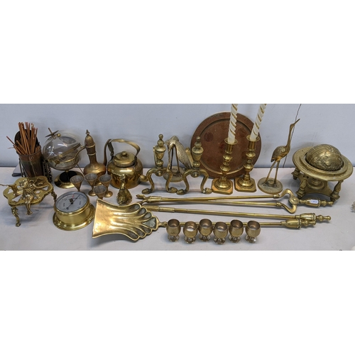 86 - A mixed lot of brassware to include fireside irons, barometer, fire dogs, trench art and other items... 