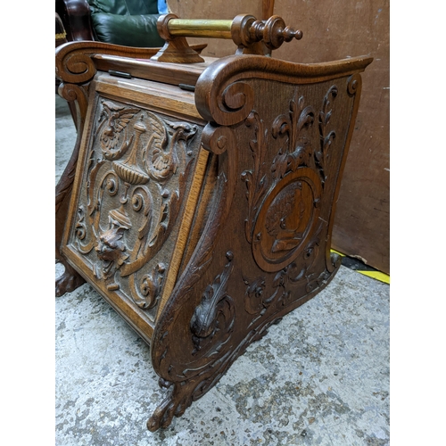 228 - A late 19th century carved oak coal scuttle with carved ornament to the front, metal liner and woode... 