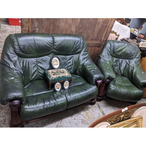 229 - A carved wooden framed and green leatherette upholstered two-seater sofa and matching armchair, remo... 