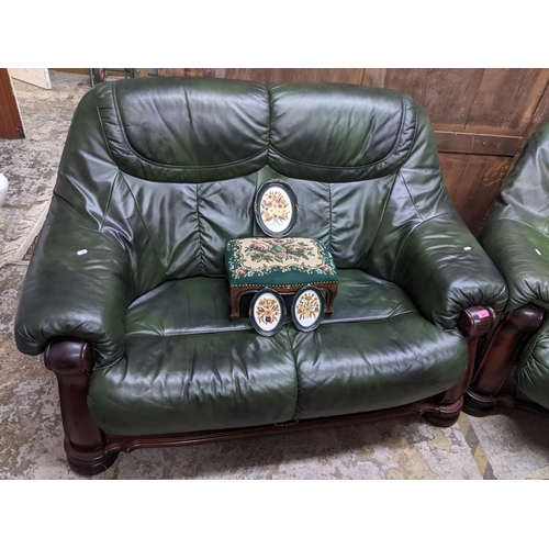 229 - A carved wooden framed and green leatherette upholstered two-seater sofa and matching armchair, remo... 