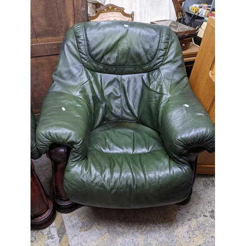 229 - A carved wooden framed and green leatherette upholstered two-seater sofa and matching armchair, remo... 