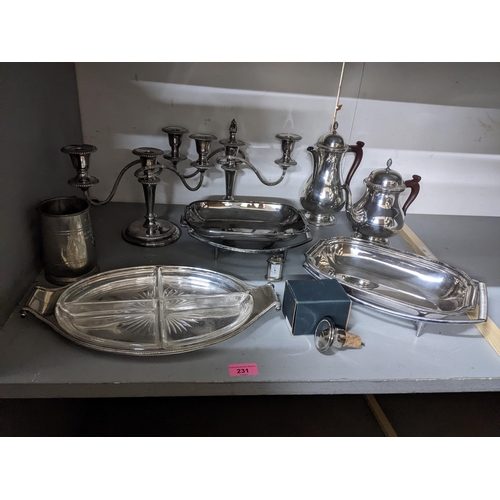 231 - A selection of silver plate and pewter ware to include a pair of candelabras, an hors d'oeuvres dish... 