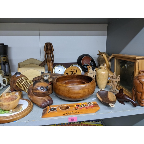 238 - A collection of wooden items from around the world to include two Indian deities, a barometer/clock ... 