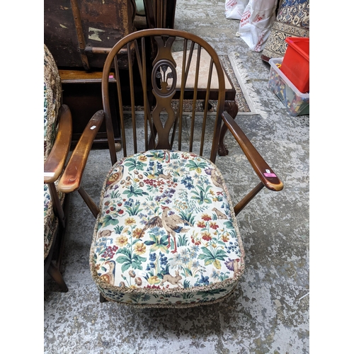 245 - Two Ercol fleur-de-Lys open armchairs with tapestry printed style loose seat and back cushions
Locat... 