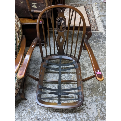 245 - Two Ercol fleur-de-Lys open armchairs with tapestry printed style loose seat and back cushions
Locat... 