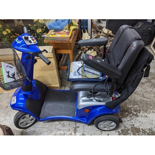 254 - A Kymco Force Super 8 mobility scooter with wirework shopping basket to front, battery charger and s... 