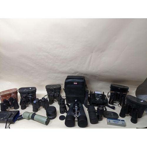 327 - A selection of glass binoculars and field glasses, camera lens, and other items to include a Visiona... 