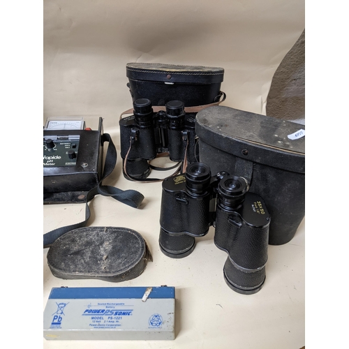 327 - A selection of glass binoculars and field glasses, camera lens, and other items to include a Visiona... 