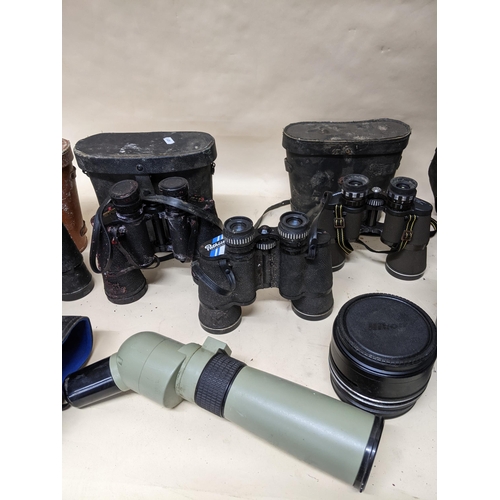 327 - A selection of glass binoculars and field glasses, camera lens, and other items to include a Visiona... 