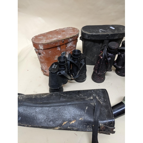 327 - A selection of glass binoculars and field glasses, camera lens, and other items to include a Visiona... 