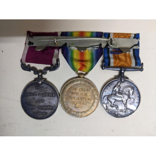 329 - A WWI long service and good conduct three-medal campaign group with ribbons on bar named to M-31523 ... 