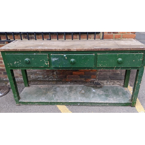 339 - A vintage green painted and pine dresser, three short drawers, the square legs united by an under-ti... 