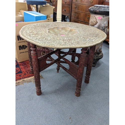 272 - A Middle Eastern brass tray table on a folding base
Location:A1B