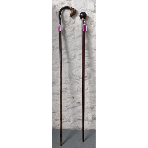 282 - Two walking sticks one with an added carved wooden dog head handle and the others, a bowling ball
Lo... 