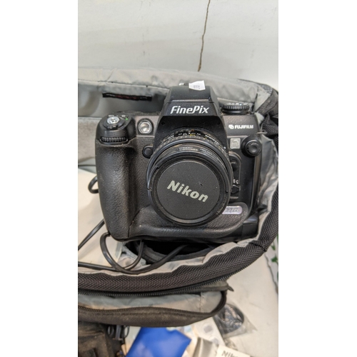 308 - Mixed photographic equipment to include a Nikon Finepix camera, camera carry bags, camera straps, op... 