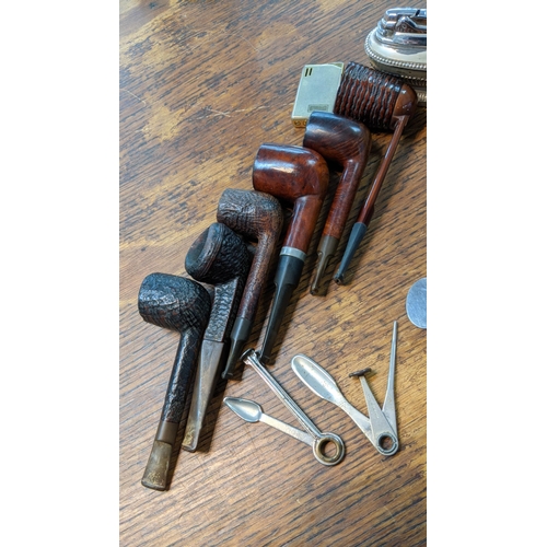 315 - A Group of vintage smoking pipes to include a falcon pipe and others along with a table top lighter ... 