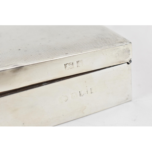 373 - An Elizabeth II silver cigarette box by Elkington & Co, Birmingham 1964, the lid with engine turned ... 