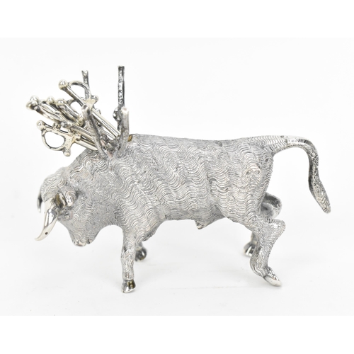 376 - A Continental silver novelty cocktail stick holder modelled as a Toro bull, with sticks shaped as sw... 