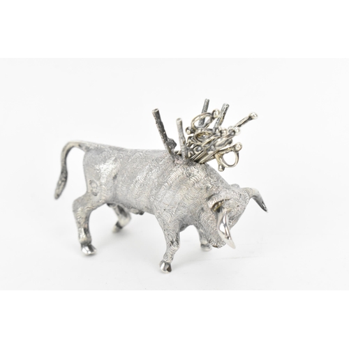 376 - A Continental silver novelty cocktail stick holder modelled as a Toro bull, with sticks shaped as sw... 