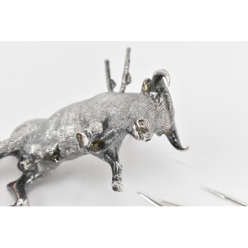 376 - A Continental silver novelty cocktail stick holder modelled as a Toro bull, with sticks shaped as sw... 