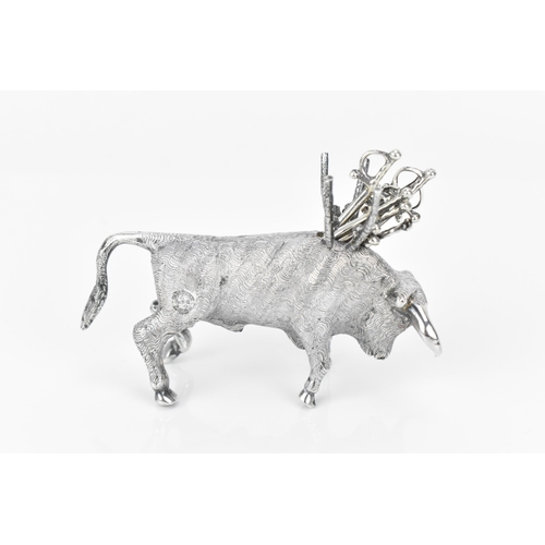 376 - A Continental silver novelty cocktail stick holder modelled as a Toro bull, with sticks shaped as sw... 