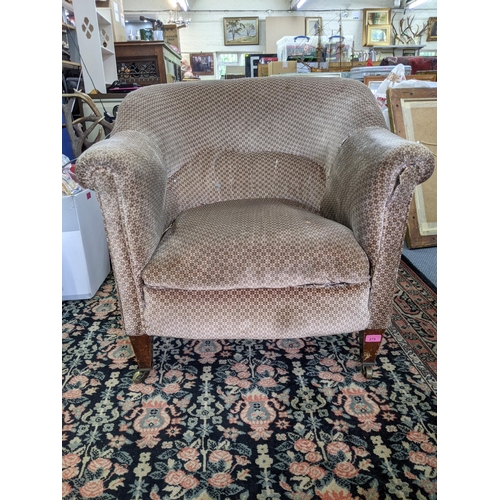 275 - An early 20th century upholstered tub chair on mahogany legs Location:RAF