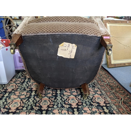 275 - An early 20th century upholstered tub chair on mahogany legs Location:RAF