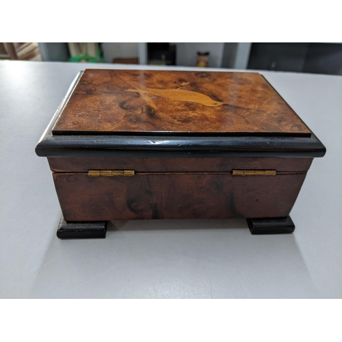 421 - A 20th century burr walnut musical box the lid inlaid with a bird
Location: P