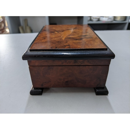 421 - A 20th century burr walnut musical box the lid inlaid with a bird
Location: P