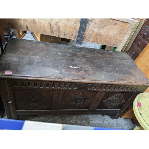 359 - An 18th century oak carved coffer, three panel front, hinged top with moulded edge, on stile feet 60... 