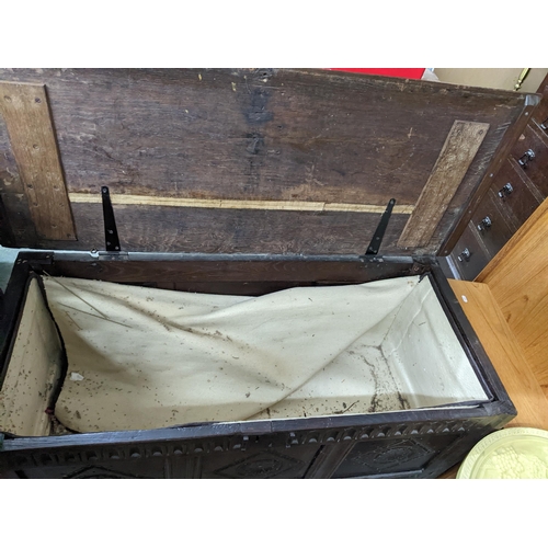 359 - An 18th century oak carved coffer, three panel front, hinged top with moulded edge, on stile feet 60... 