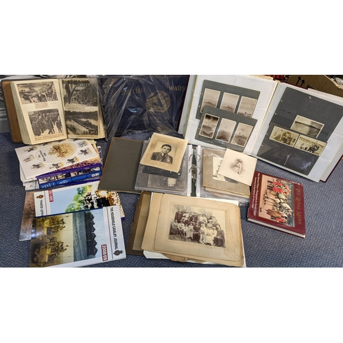 389 - A selection of mainly military related ephemera to include a scrap album, photograph albums and othe... 