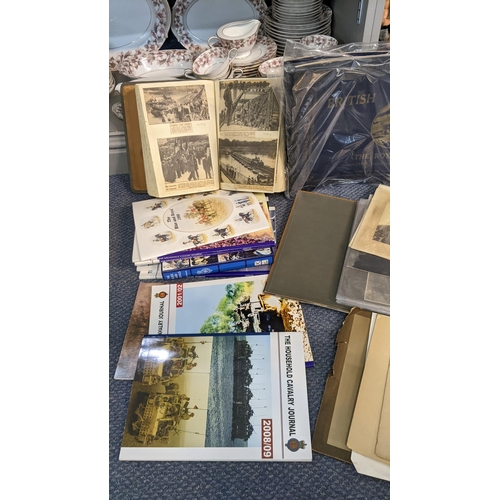 389 - A selection of mainly military related ephemera to include a scrap album, photograph albums and othe... 