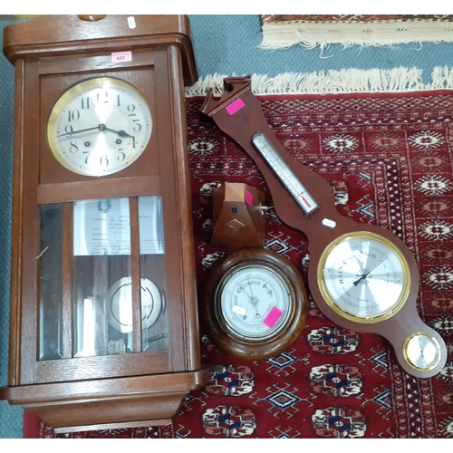 495 - A Westminster chime wall clock with key in oak case together with a circular oak cased wall baromete... 