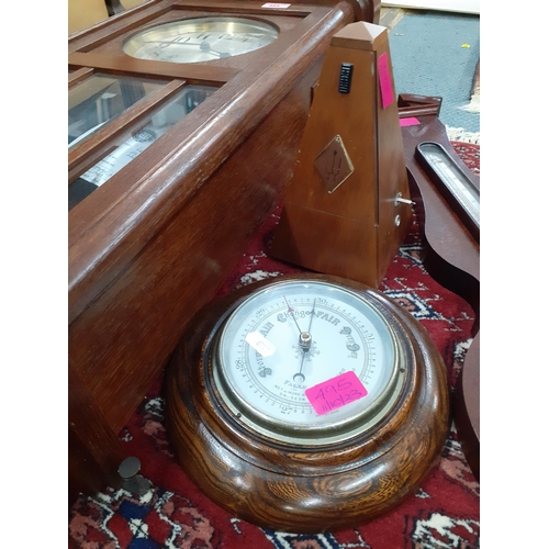 495 - A Westminster chime wall clock with key in oak case together with a circular oak cased wall baromete... 