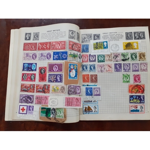 513 - Loose stamps of the World, a stamp album, a partial album of First Day covers, stamps and franked en... 