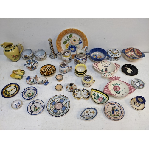 531 - A Quimper collection to include 19th century and later examples, jugs, inkwell dishes, ash trays, va... 