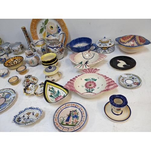 531 - A Quimper collection to include 19th century and later examples, jugs, inkwell dishes, ash trays, va... 