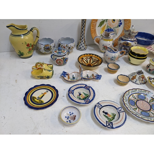 531 - A Quimper collection to include 19th century and later examples, jugs, inkwell dishes, ash trays, va... 