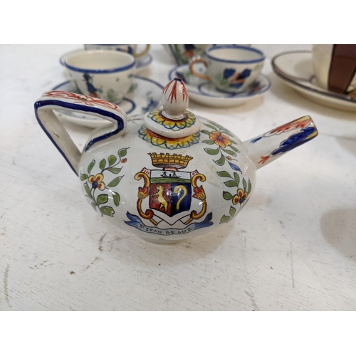 532 - Drinking related Quimper ware to include a matching teapot, large cup and saucer, tea pots, a set of... 