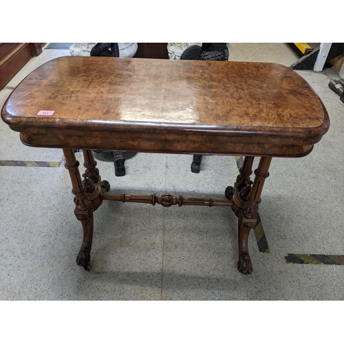 533 - A Victorian fold over swivel top walnut card table on turned columns and splayed legs 74cm x 92cm x ... 