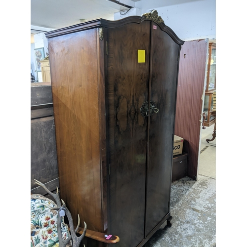 539 - Early 20th century walnut single wardrobe, twin doors with crossbanding, brass handles and escutcheo... 