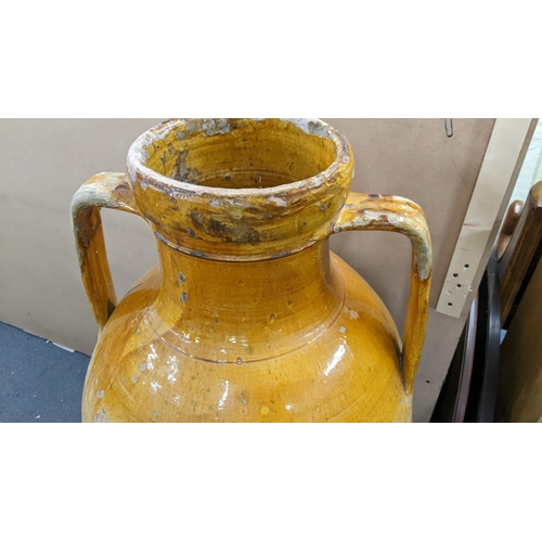 499 - A 19th century large twin handled Orcio wine/olive oil jar having a majolica glaze 107.5cm h x 55cm ... 