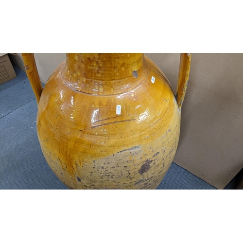 499 - A 19th century large twin handled Orcio wine/olive oil jar having a majolica glaze 107.5cm h x 55cm ... 