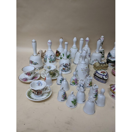 343 - A group of porcelain collectables to include various pill boxes, porcelain bells, mini cups and sauc... 