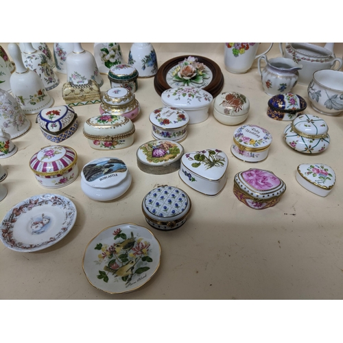 343 - A group of porcelain collectables to include various pill boxes, porcelain bells, mini cups and sauc... 