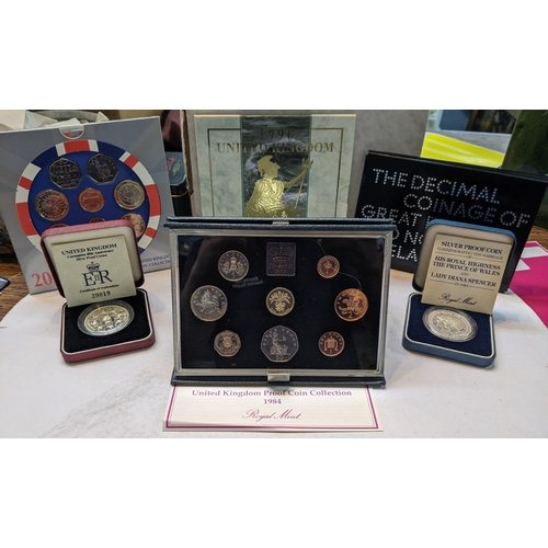 506 - A collection of UK Proof coins and coin sets to include 1971, 1984, 1996 and 2005 sets, cased Corona... 